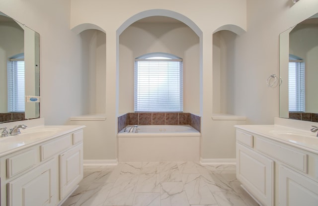 bathroom featuring a washtub and vanity