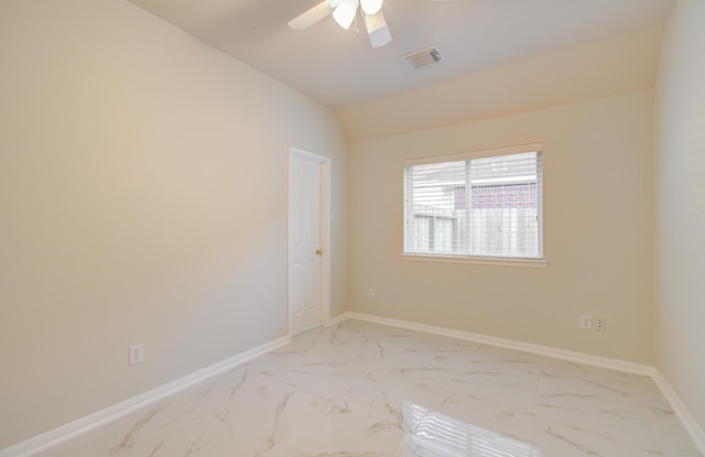 empty room featuring ceiling fan and vaulted ceiling