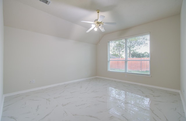 empty room with ceiling fan and lofted ceiling