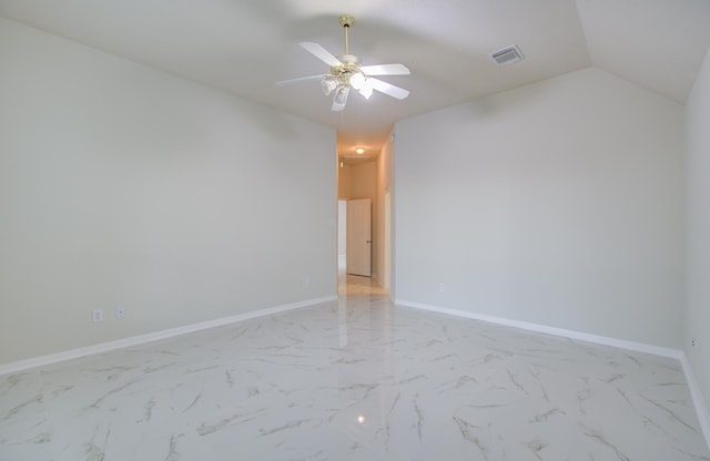 empty room with ceiling fan and lofted ceiling