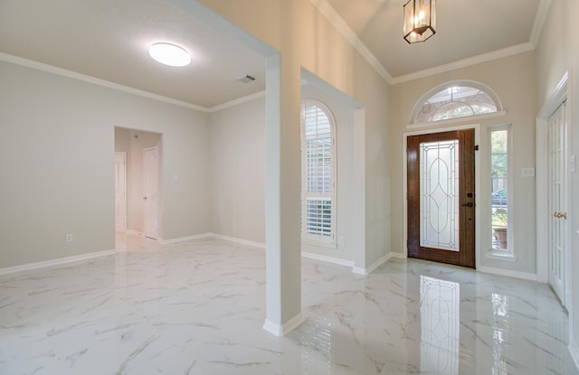 entryway featuring a wealth of natural light and crown molding