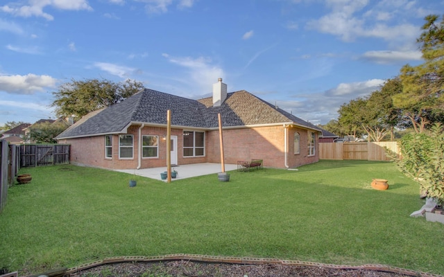 rear view of property with a patio area and a yard