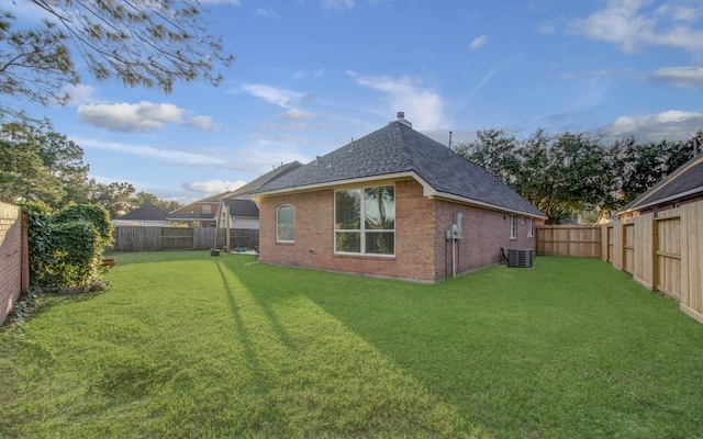 rear view of house featuring a yard