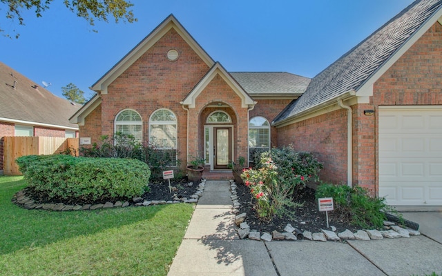 view of front of home with a front yard and a garage