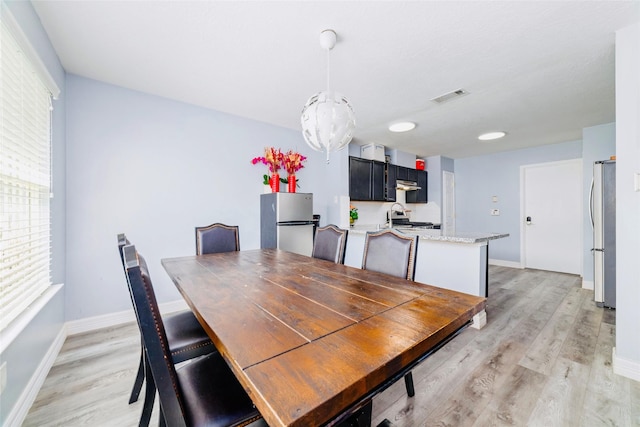 dining area with light hardwood / wood-style flooring