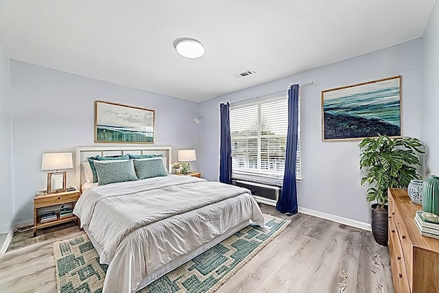 bedroom with hardwood / wood-style floors