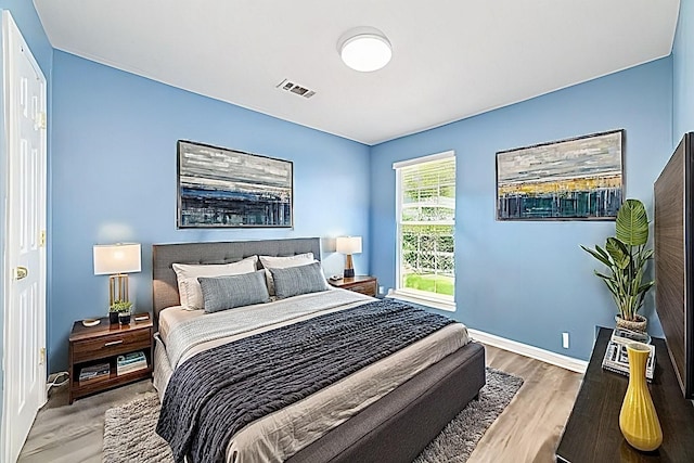 bedroom with hardwood / wood-style floors