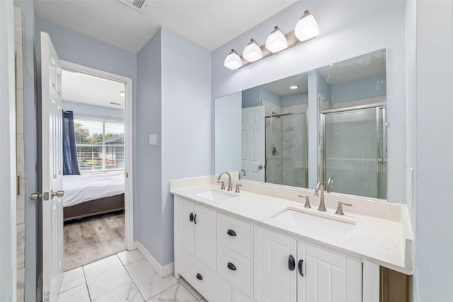 bathroom with vanity and a shower with door