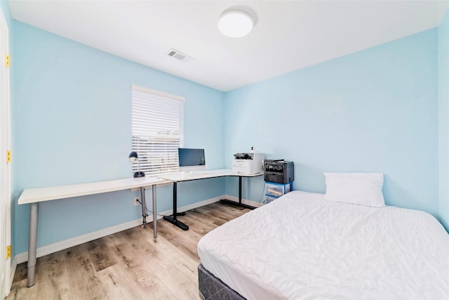 bedroom with light wood-type flooring