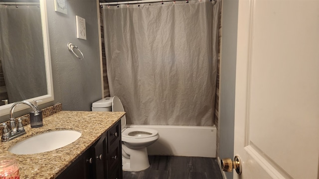 full bathroom featuring shower / tub combo with curtain, vanity, toilet, and hardwood / wood-style floors