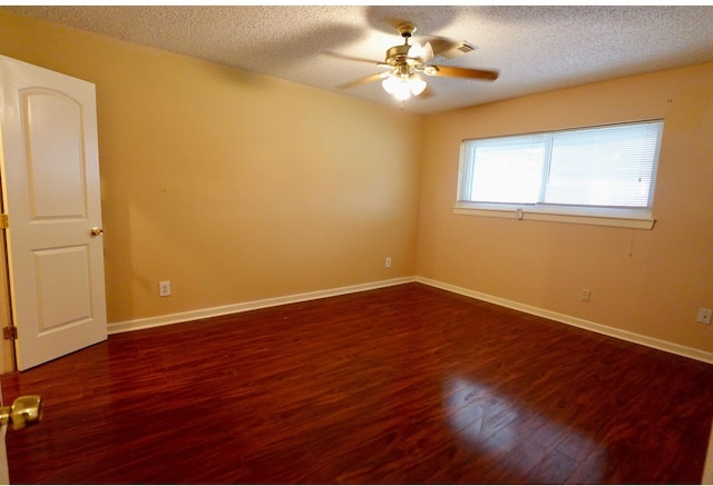 unfurnished room featuring dark wood-type flooring, ceiling fan, and a textured ceiling