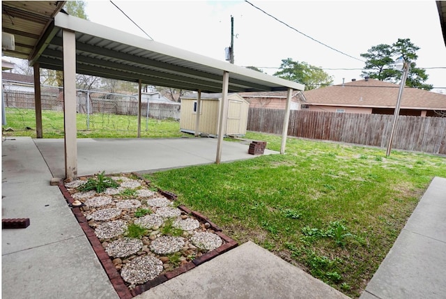 view of yard featuring a storage shed and a patio area