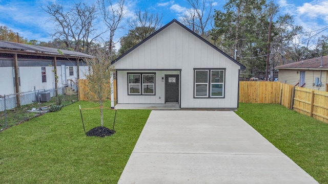 exterior space featuring central air condition unit, a patio area, and a front lawn