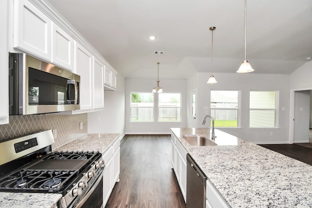 kitchen featuring backsplash, white cabinets, sink, light stone counters, and stainless steel appliances