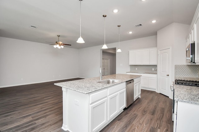 kitchen with white cabinets, sink, a kitchen island with sink, and stainless steel appliances