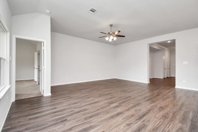 unfurnished living room featuring ceiling fan and dark wood-type flooring