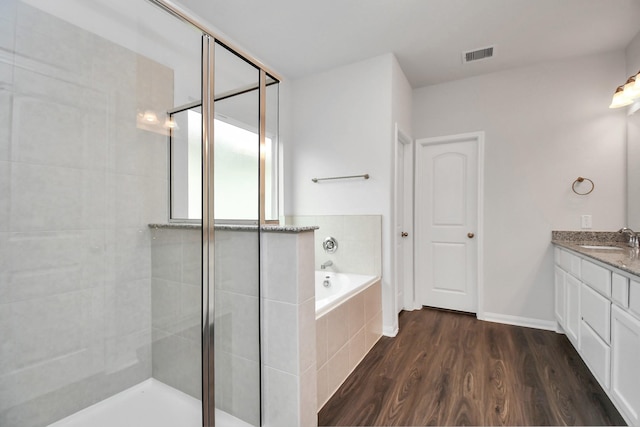 bathroom featuring wood-type flooring, vanity, and independent shower and bath