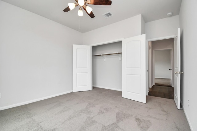 unfurnished bedroom with ceiling fan, a closet, and light carpet