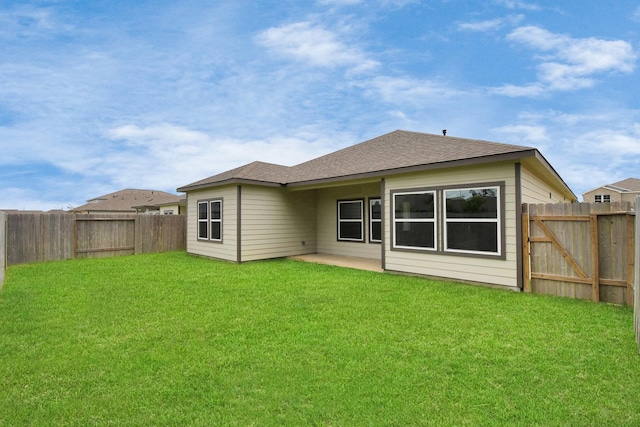 back of house featuring a yard