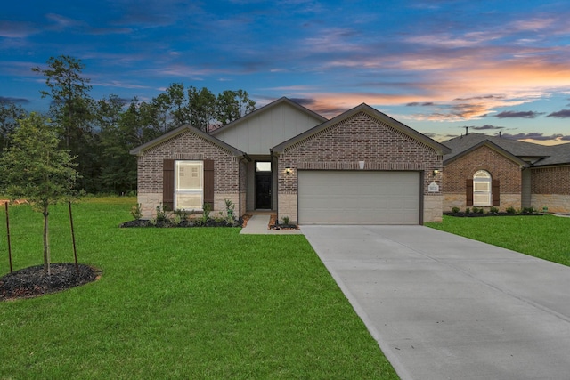 view of front facade with a lawn and a garage