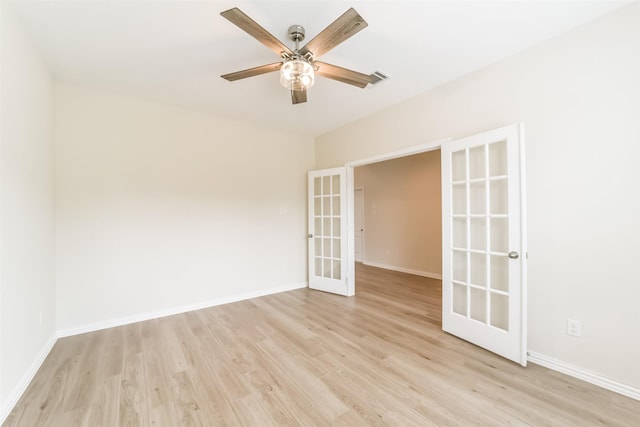 spare room with ceiling fan, light hardwood / wood-style flooring, and french doors