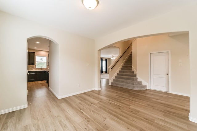 spare room featuring light hardwood / wood-style flooring and ceiling fan