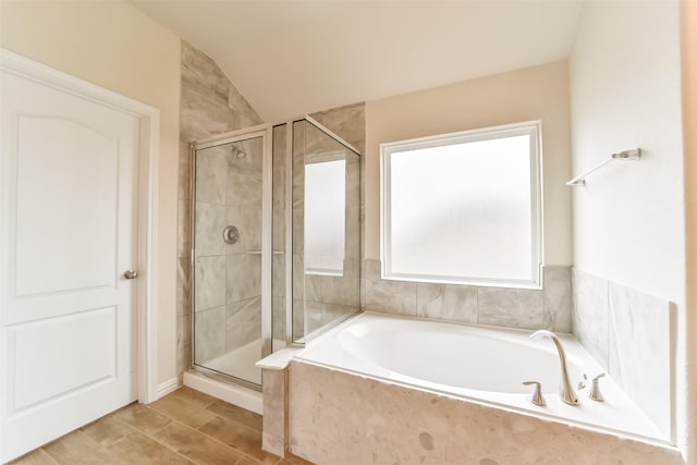 bathroom with separate shower and tub and lofted ceiling