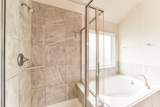 bathroom featuring plus walk in shower and vaulted ceiling