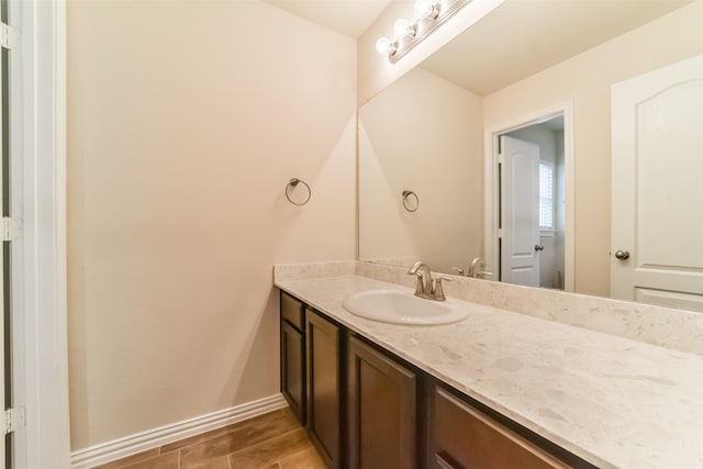 bathroom with hardwood / wood-style flooring and vanity