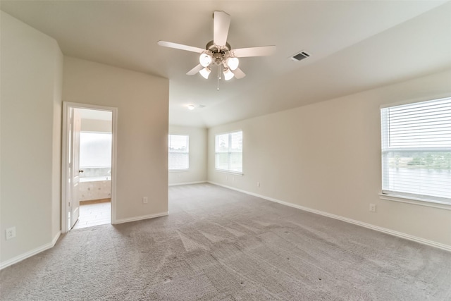 carpeted spare room with ceiling fan