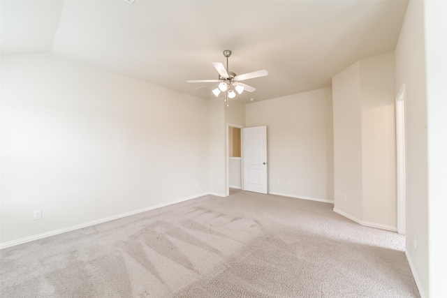 empty room with ceiling fan, light carpet, and vaulted ceiling