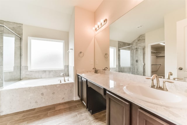 bathroom with plus walk in shower, vanity, and vaulted ceiling