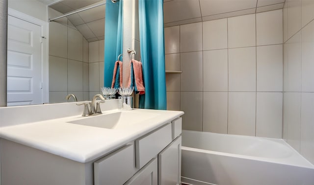 bathroom featuring vanity, shower / bath combo with shower curtain, and lofted ceiling