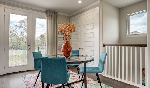 dining room with a wealth of natural light, hardwood / wood-style floors, and ornamental molding