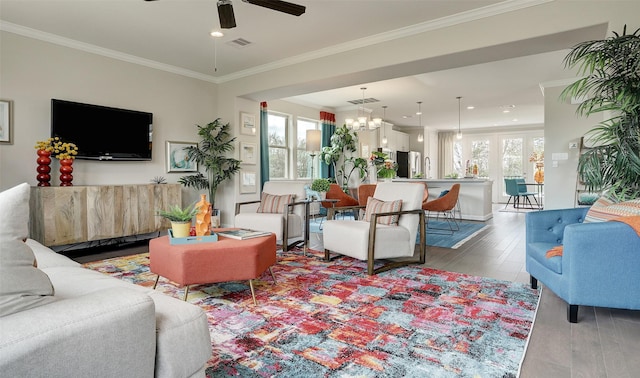 living room featuring hardwood / wood-style flooring, plenty of natural light, and ornamental molding