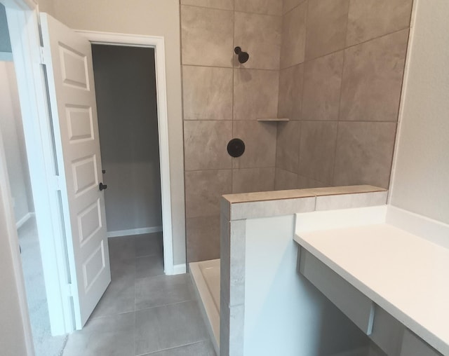 bathroom featuring tile patterned flooring and tiled shower