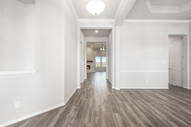 hallway with dark hardwood / wood-style floors and ornamental molding