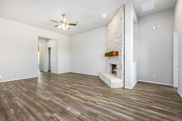 unfurnished living room featuring a fireplace, ceiling fan, and dark wood-type flooring