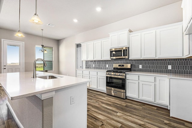 kitchen with white cabinetry, sink, stainless steel appliances, and dark hardwood / wood-style floors