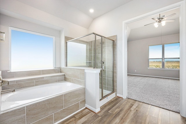 bathroom with ceiling fan, wood-type flooring, independent shower and bath, and vaulted ceiling