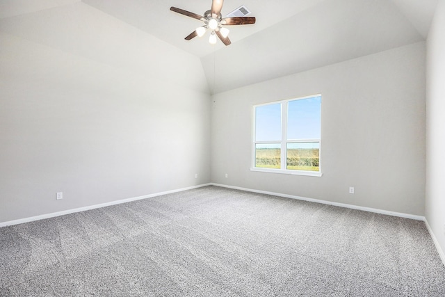 spare room with ceiling fan, lofted ceiling, and carpet floors