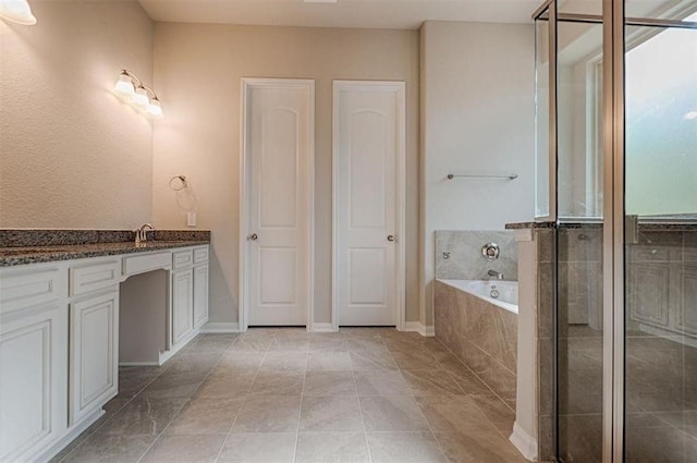 bathroom featuring tile patterned floors, vanity, and plus walk in shower