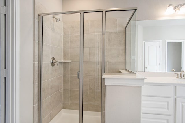 bathroom featuring vanity and an enclosed shower