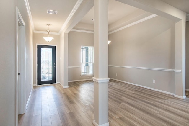 entryway featuring light wood-type flooring and crown molding