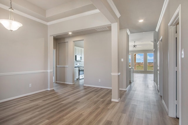 hallway with light hardwood / wood-style floors and ornamental molding