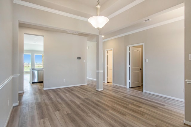 empty room featuring ornamental molding and hardwood / wood-style flooring