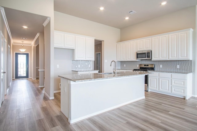 kitchen with white cabinets, sink, and appliances with stainless steel finishes