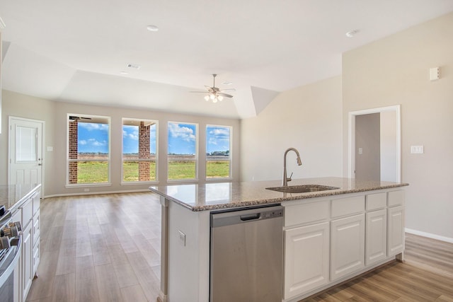 kitchen featuring sink, stainless steel dishwasher, light hardwood / wood-style floors, a center island with sink, and white cabinets