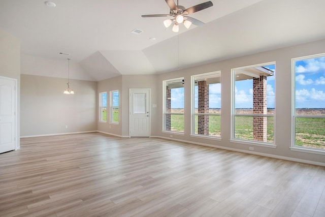 interior space with lofted ceiling, light hardwood / wood-style flooring, and ceiling fan with notable chandelier