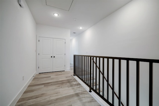 hallway with light hardwood / wood-style flooring